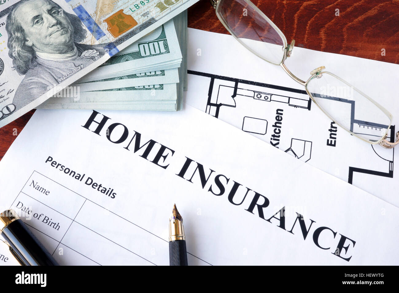 Home insurance policy on a wooden surface. Stock Photo