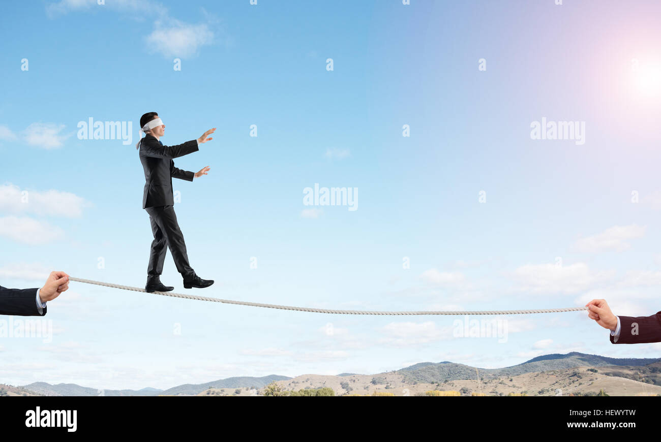 Business concept of risk support and assistance with man balancing on ...