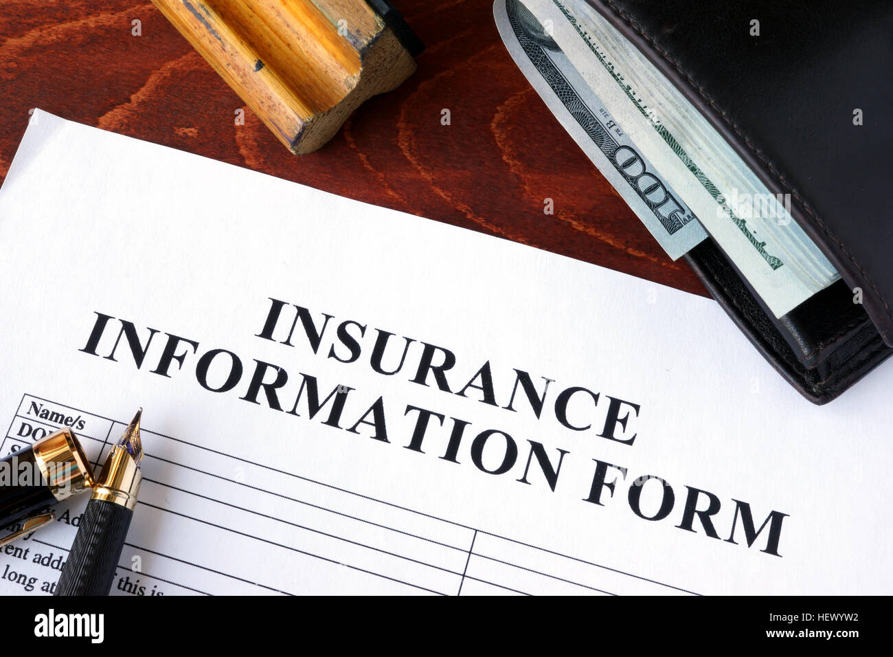 Insurance information form  and wallet on a table. Stock Photo