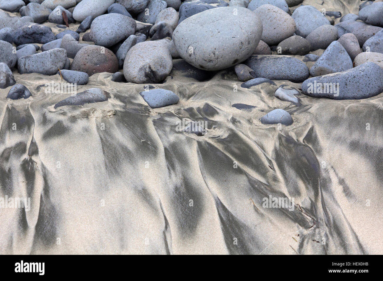 Interesting pattern of rocks and sand Stock Photo - Alamy