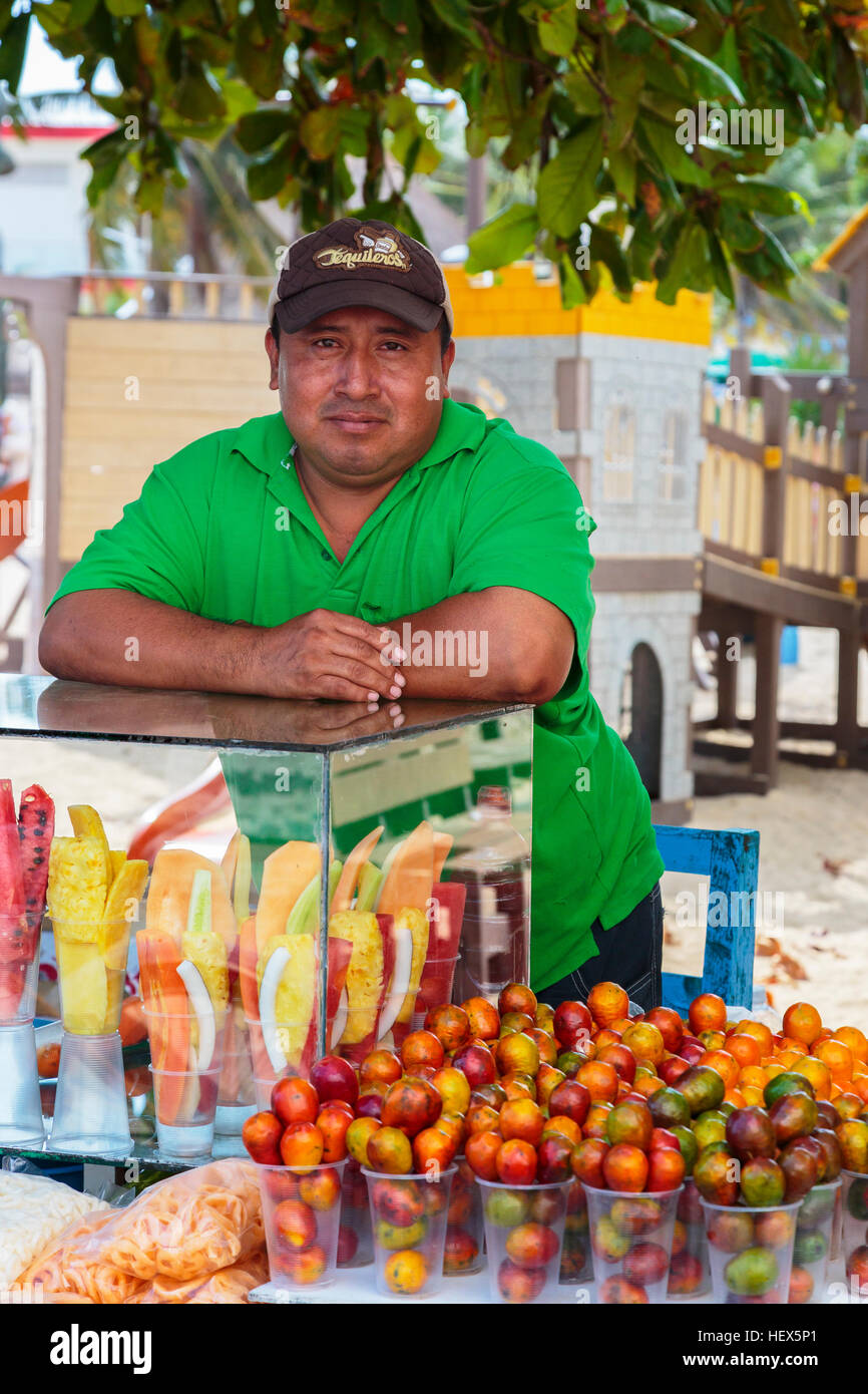 man selling fresh fruit from a stall on 5th Avenue, Playa Del Carmen, Riviera Maya, Mexico Stock Photo