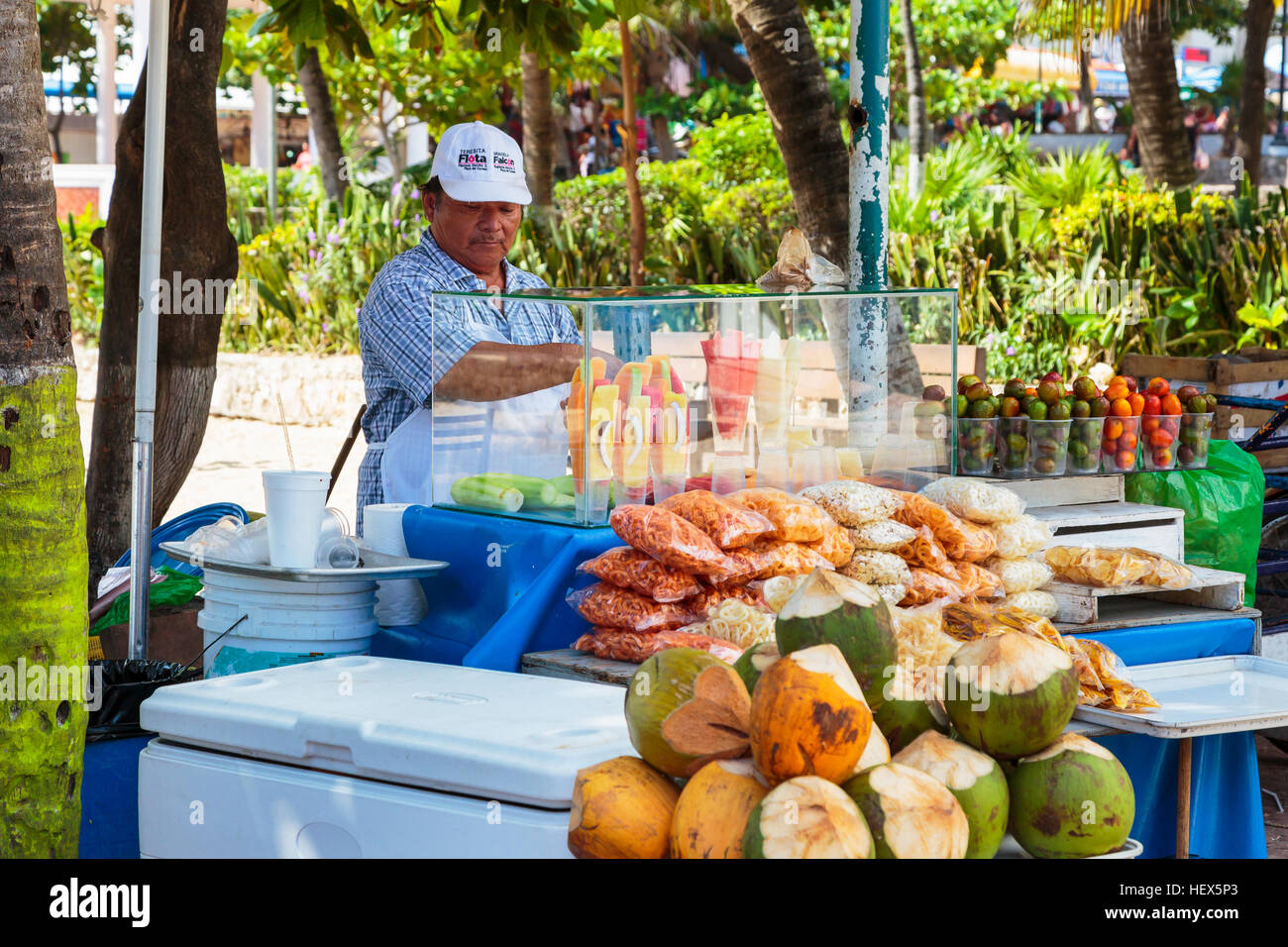 Man selling fresh fruit and corn snacks from a stall on 5th Avenue, Playa Del Carmen, Riviera Maya, Mexico Stock Photo