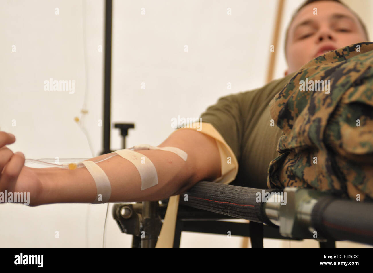 A Marine receives saline fluids intravenously at an expeditionary flight line medical aid station here, Oct. 9. Comprised of 22 corpsman and doctors, the medical staff is prepared to treat a wide variety of ailments Marines and their Filipino counterparts may encounter during the upcoming Amphibious Landing Exercise 2011, Oct. 14-22. Phiblex '11 is a bilateral training exercise between the U.S. Marine Corps and the Armed Forces of the Philippines, part of the long-term security program between the two countries. By training in the Philippines, it allows the medical personnel of 3rd MEB to hone Stock Photo