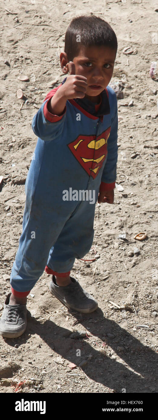 An Afghan boy dressed as Superman shows his appreciation for coalition forces by giving a thumbs up  in Ghazni, Afghanistan, Nov.  26, 2010. (Photo by: Sgt. Justin Howe) Flickr - DVIDSHUB - Patrol Through Ghazni (Image 15 of 18) Stock Photo
