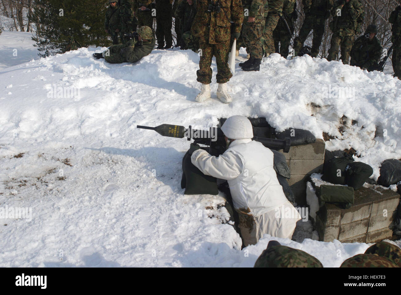 A Japanese Ground Self Defense Force (JGSDF) Soldier from the 20th Infantry Regiment (dressed in white cold-weather gear), prepares to engage targets down range with a Panzerfaust 3-T 600 Light Anti-tank Weapon, during a live fire exercise conducted at the snow covereded Ojojibara Maneuver Area of Sendai, Japan, while participating in Exercise FOREST LIGHT 2004. Forest Light is a bi-lateral training exercise conducted between the US Marine Corps (USMC) and the JGSDF. Japanese 20th Infantry Regiment soldier with Panzerfaust 3 2-12-04 Stock Photo