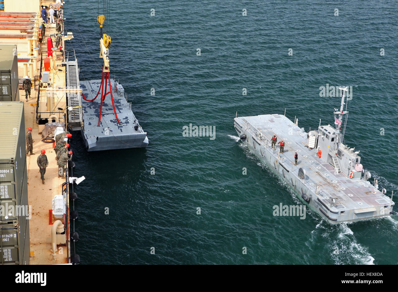 A crane offloads a beach landing module from USNS Sgt. William Button ...