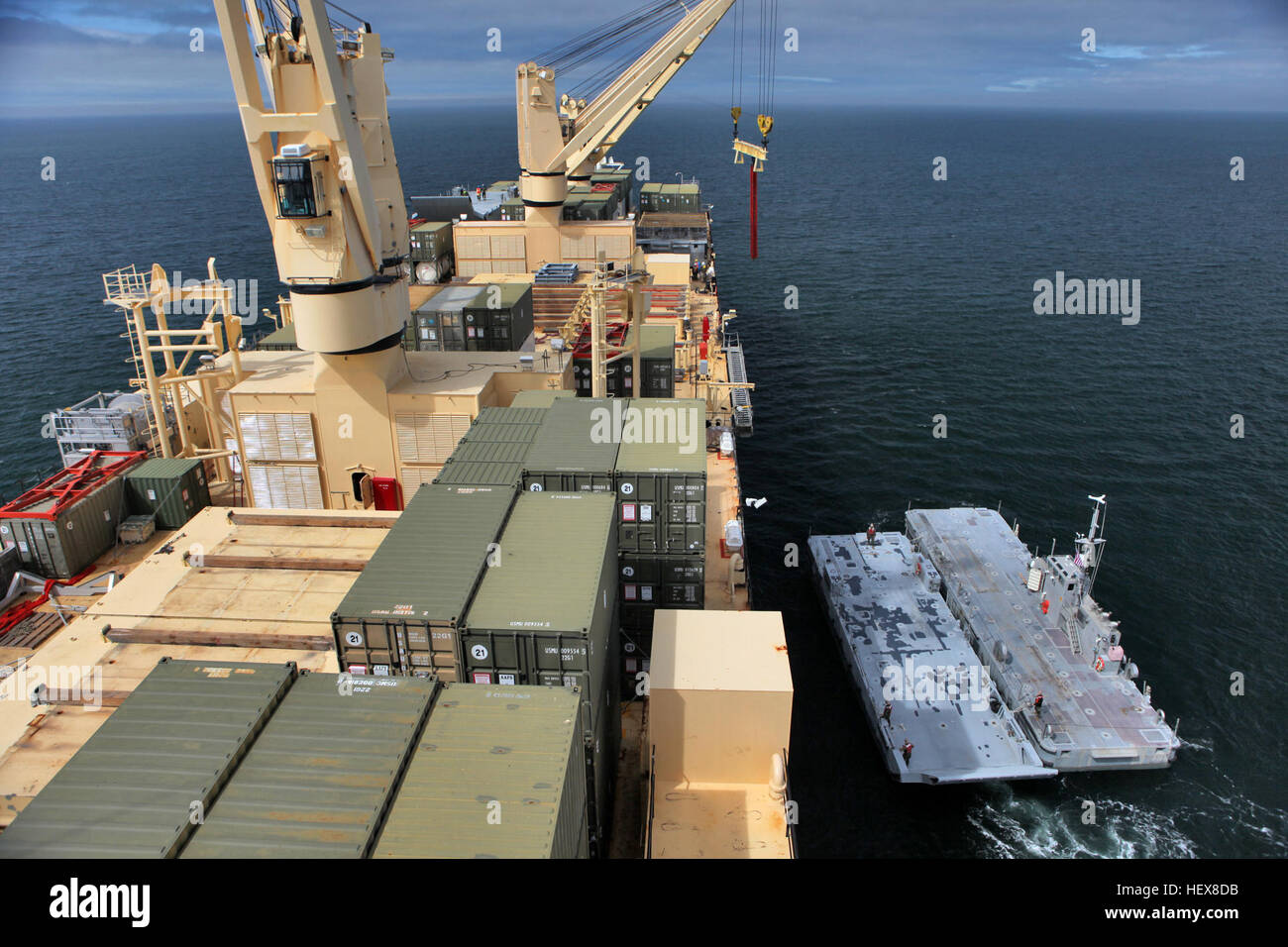 A crane offloads a beach landing module off the USNS Sgt. William ...