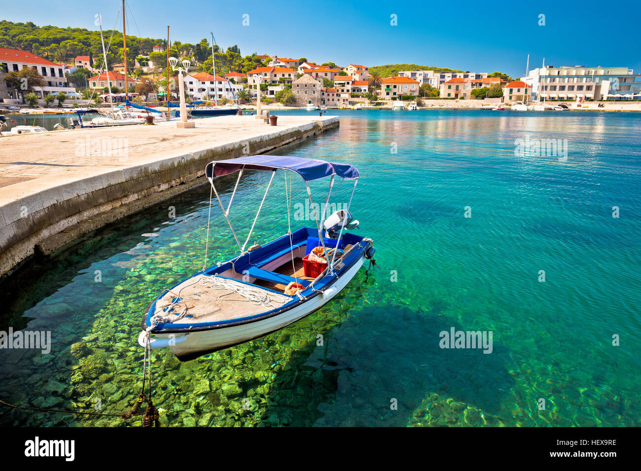 Turquoise coast and boat in Postira, Island of Brac, Dalmatia, Croatia Stock Photo