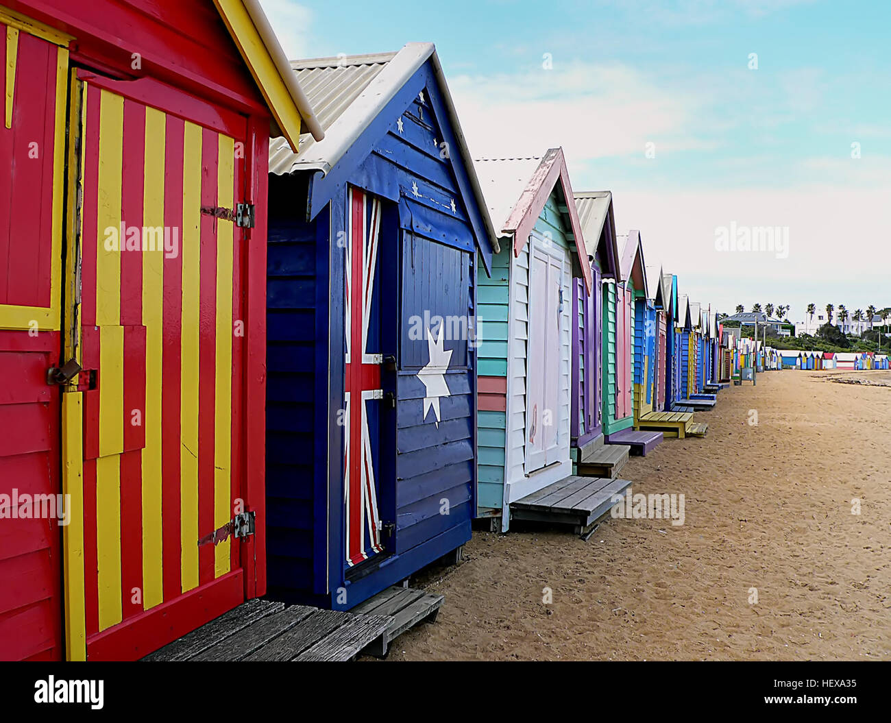 The 82 Brighton bathing boxes are unique because of their uniform scale and proportion, building materials, sentry order alignment and a Planning Scheme Heritage Overlay on a beach owned by Bayside City Council. As simple structures, all retain classic Victorian architectural features with timber framing, weatherboards and corrugated iron roofs. They remain as they did over one hundred years ago, as licensed bathing boxes. No service amenities such as electricity or water are connected. Stock Photo