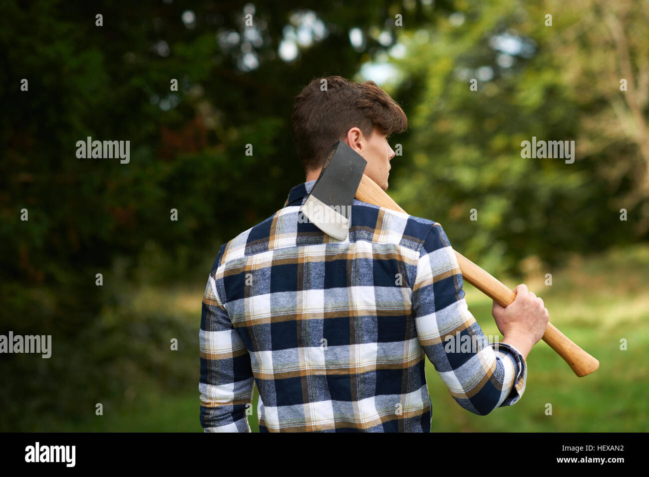Man carrying an axe on his shoulder hires stock photography and images