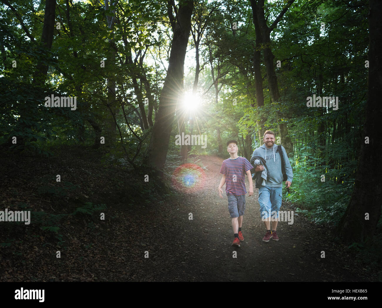 Father and son walking in forest Stock Photo