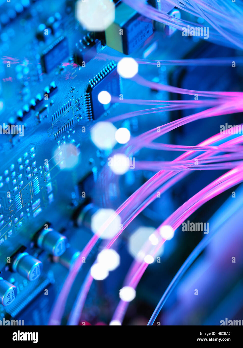 Fibre optics shooting past electronics of broadband hub Stock Photo