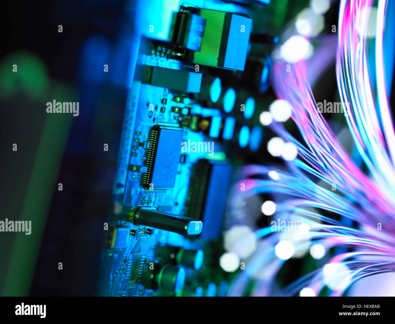 Cyber attack with fibre optics shooting past electronics of broadband hub Stock Photo