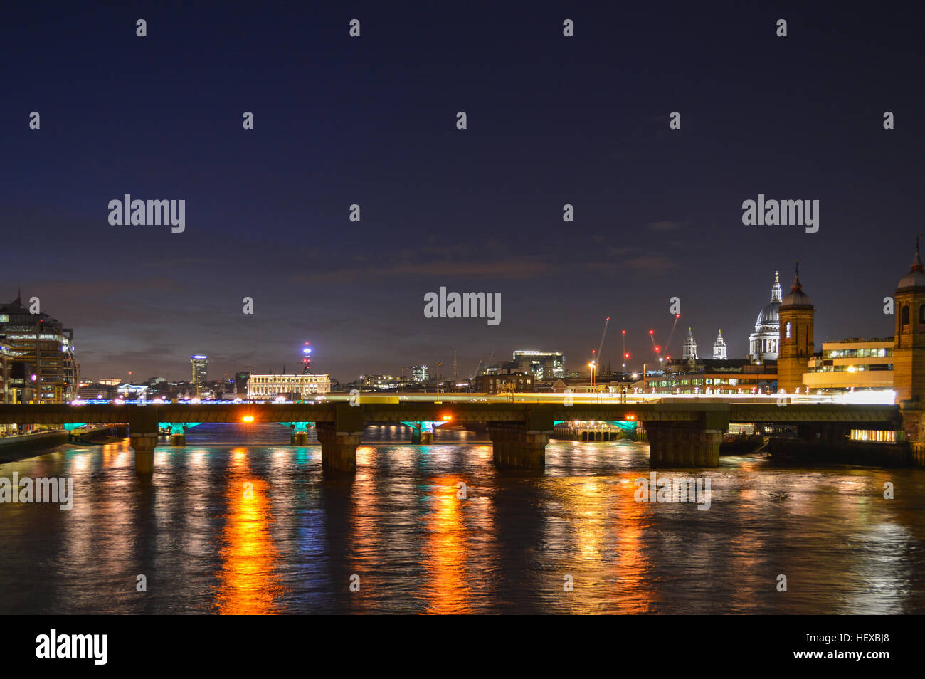 Cityscape of London at night, precisely the Southwark bridge with St. Paul’s Cathedral in the Background. Stock Photo