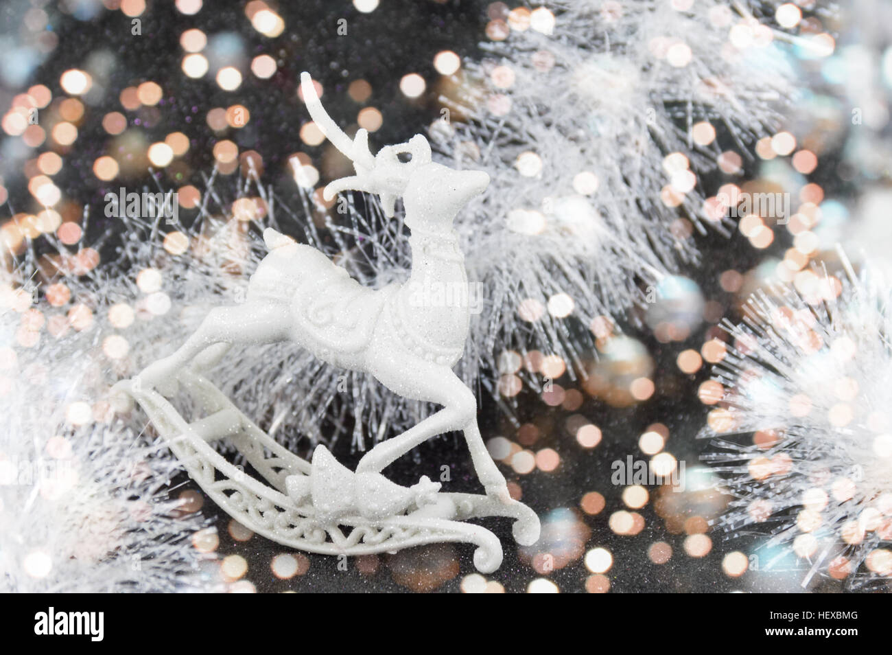 Silver reindeer toy on dark festive background Stock Photo