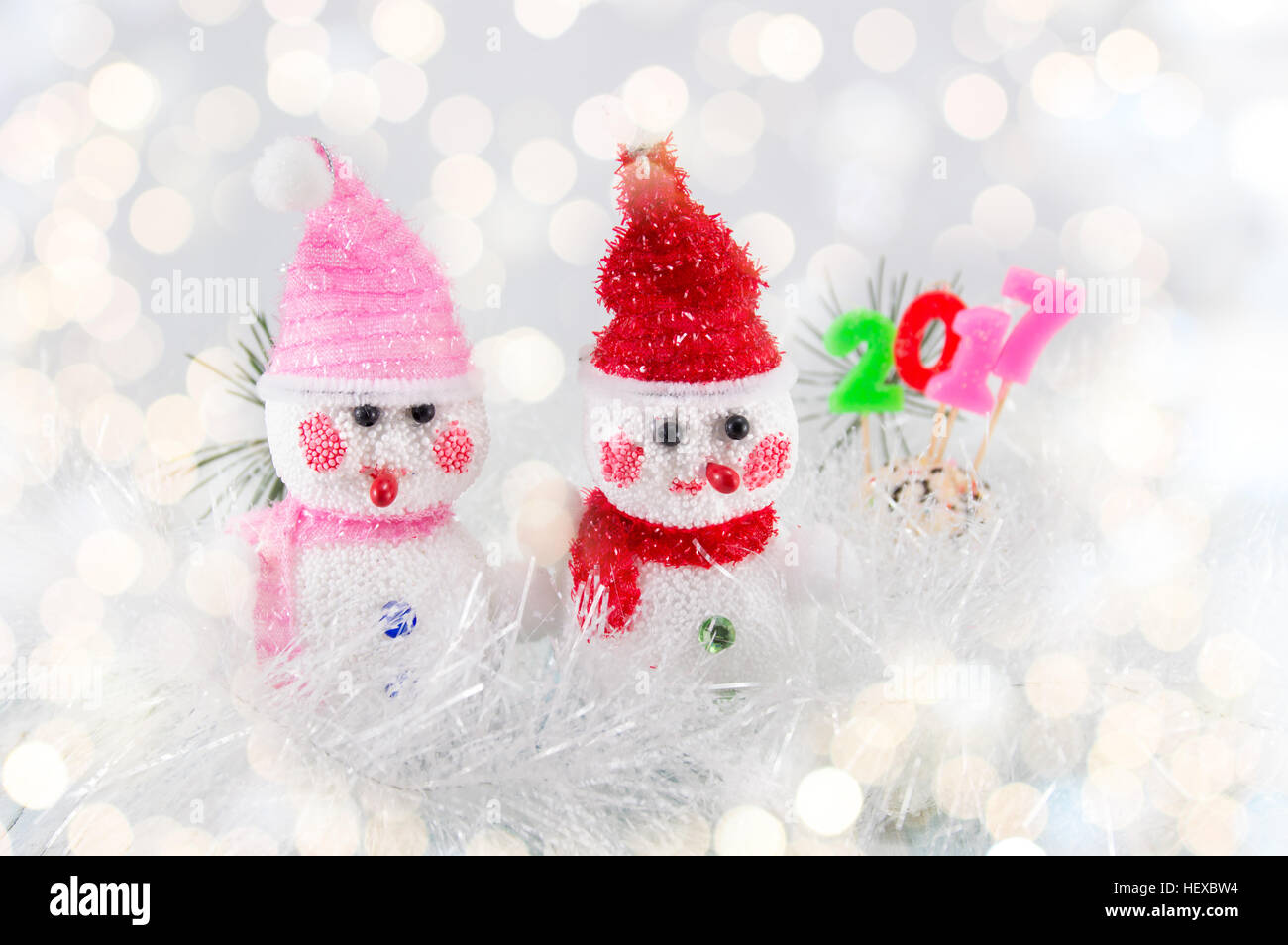 Two toy snowman with 2017 sign and festive Christmas background Stock Photo