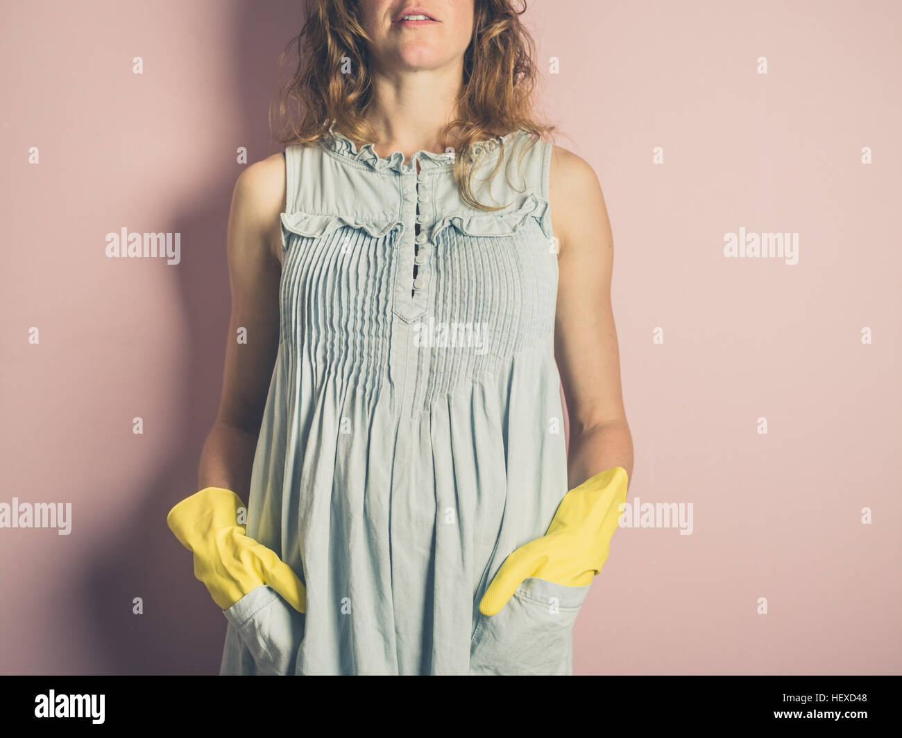 A young woman is wearing yellow rubber gloves Stock Photo - Alamy