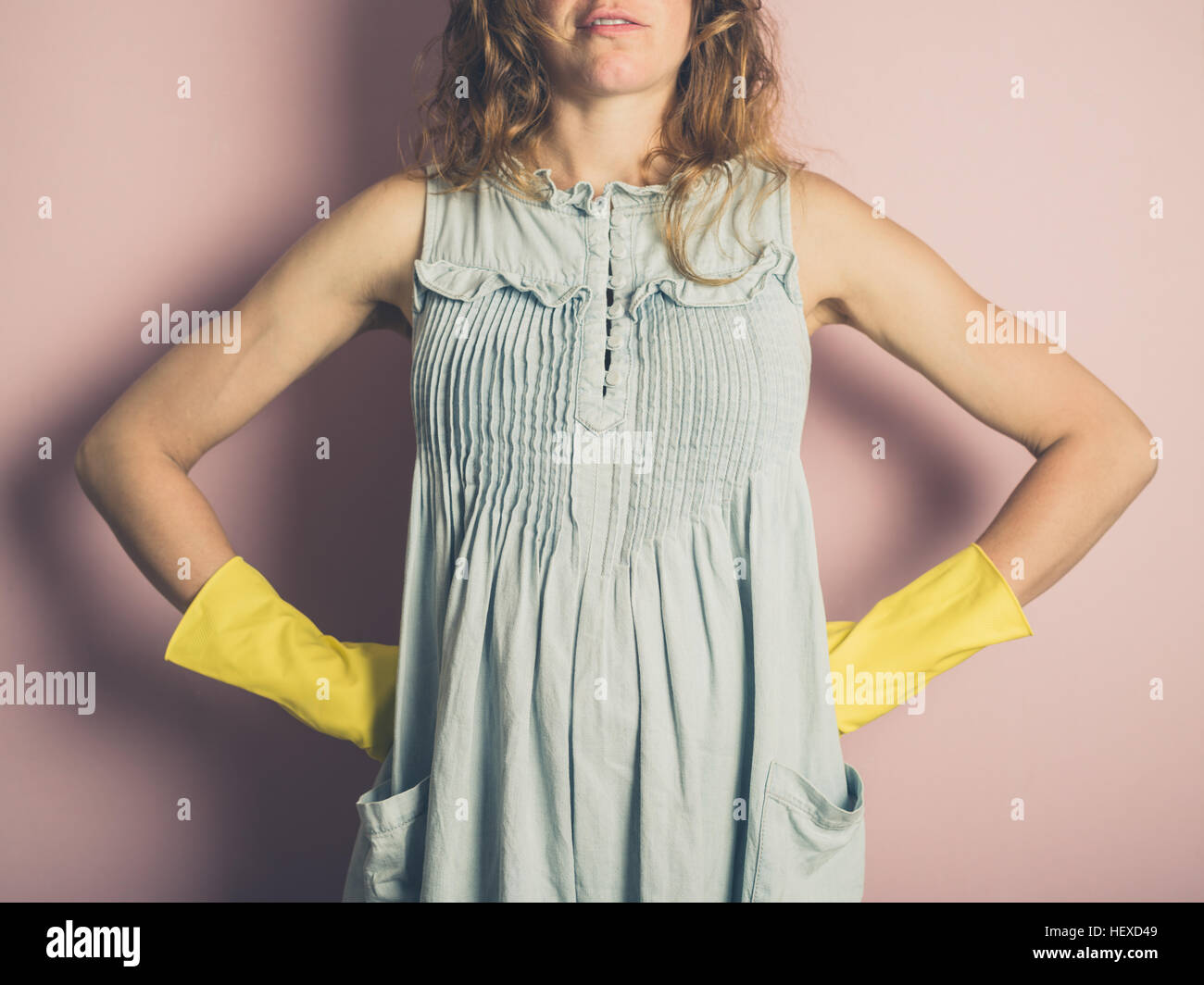 A young woman is wearing yellow rubber gloves Stock Photo - Alamy