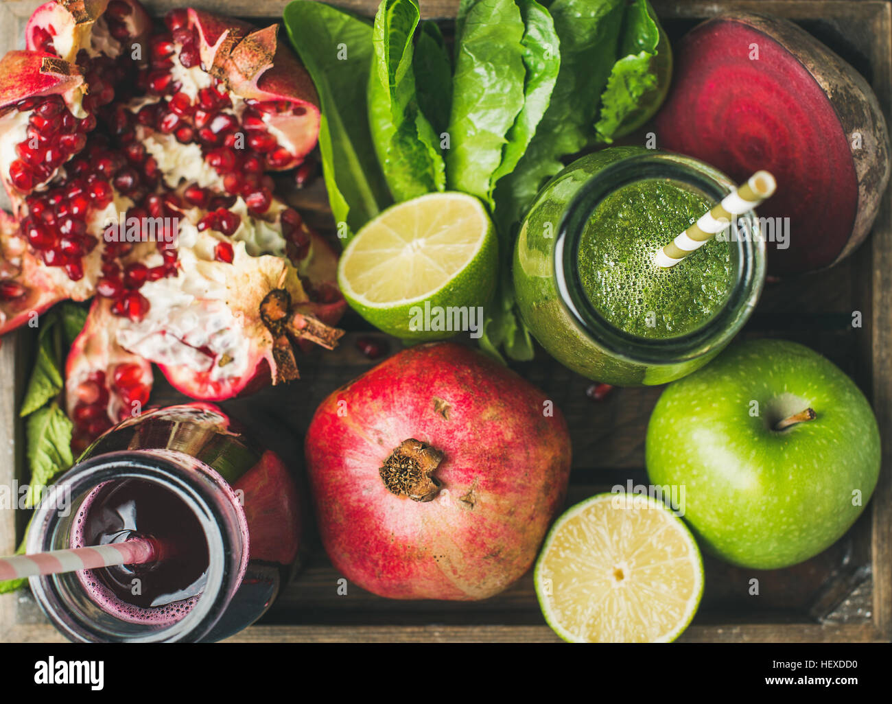 Closeup of green and purple fresh juices with fruits, vegetables Stock