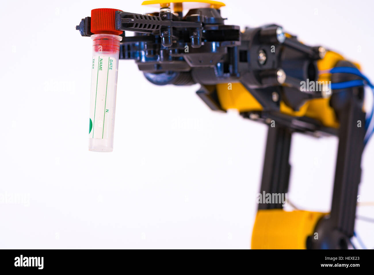 Robotic arm holding test tube against a white background Stock Photo ...