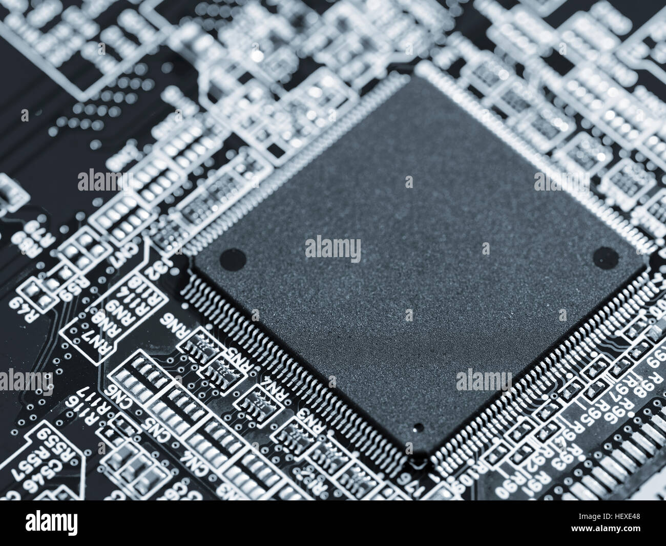 Silicon chip on a circuit board microprocessor. Stock Photo