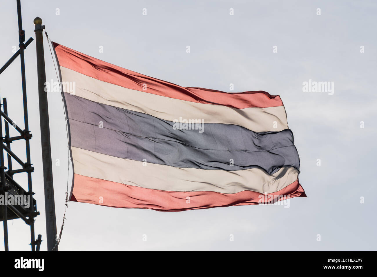 Thailand flag waving in the wind with beautiful blue sky and sunlight Stock Photo