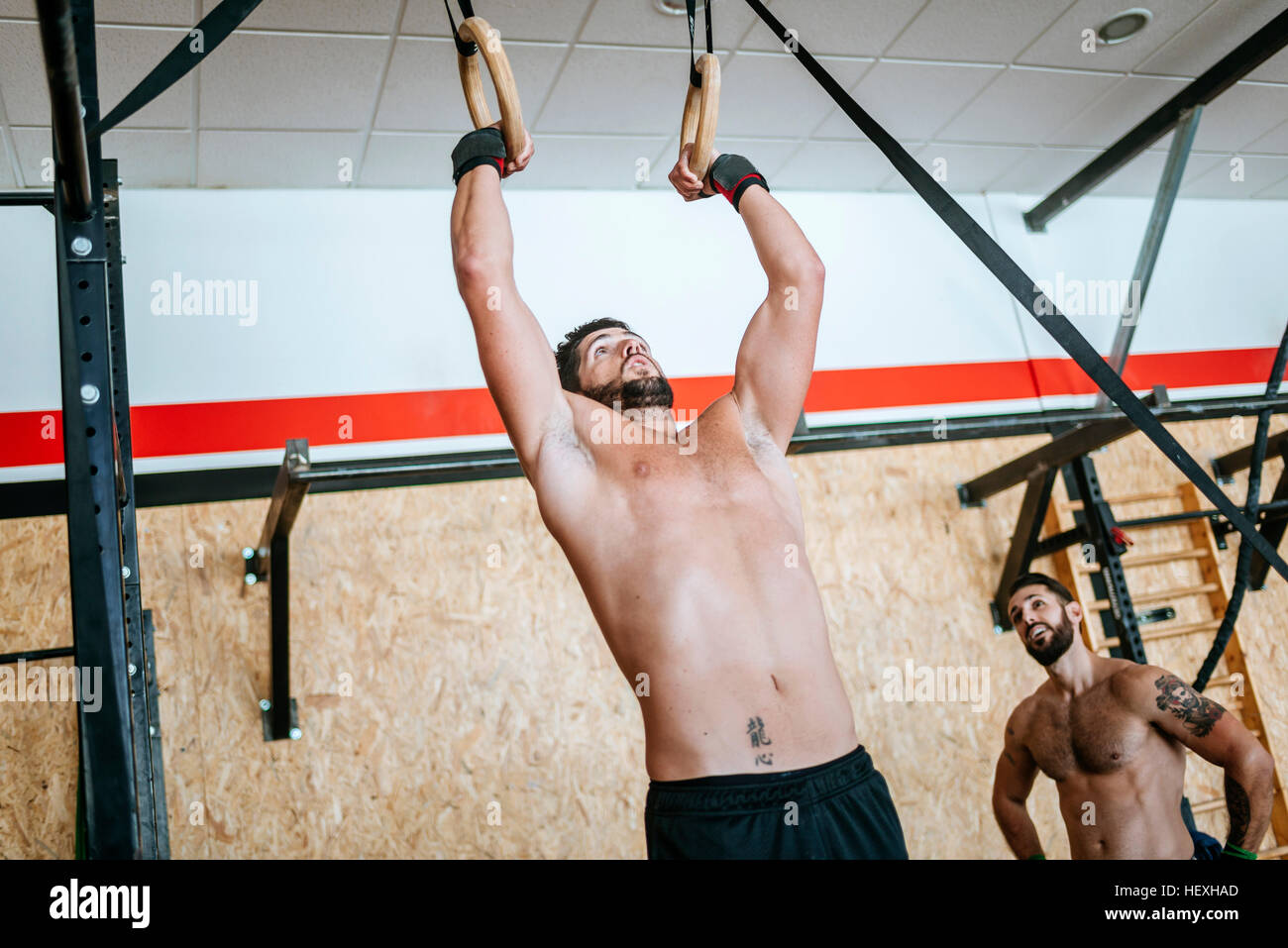 Man doing exercises on rings in gym Stock Photo Alamy