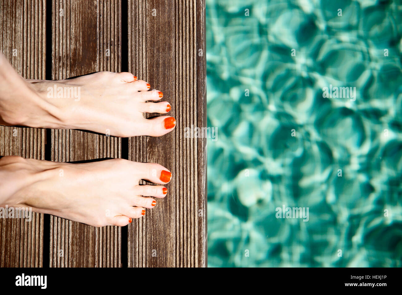 Female feet standing at pool's edge Stock Photo - Alamy