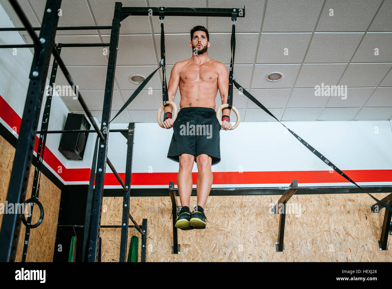 Man doing exercises on rings in gym Stock Photo Alamy