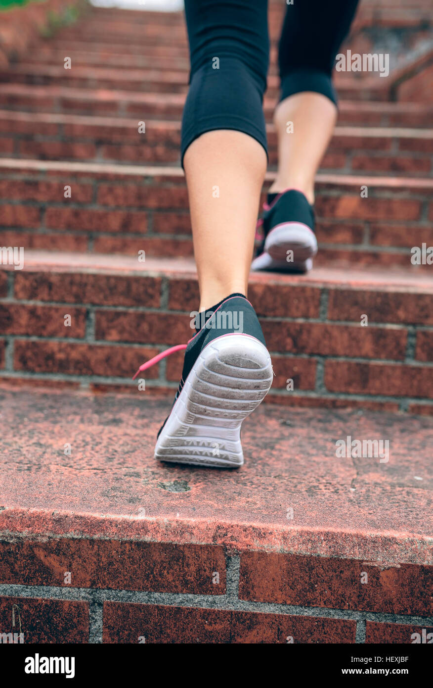 Woman running up stairs Stock Photo Alamy
