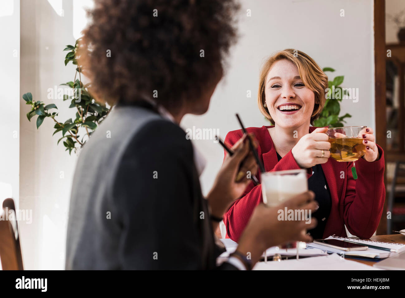 Two young women in a cafe Stock Photo - Alamy