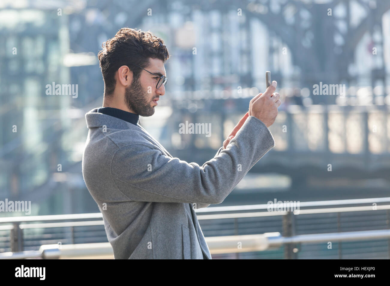 Young businessman taking picture with smartphone Stock Photo