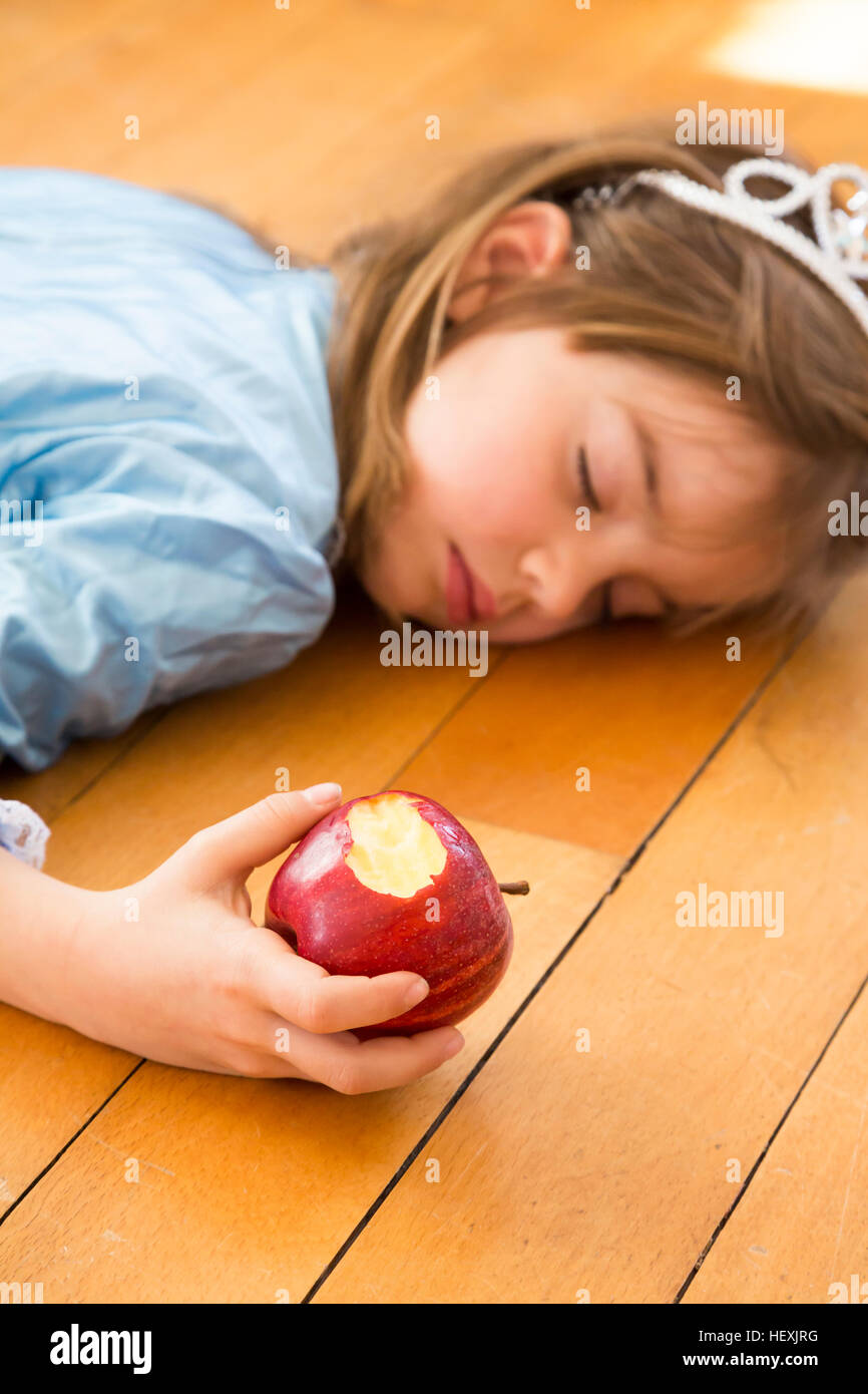 A Little Girl on a Wooden Floor Stock Image - Image of cute, rest