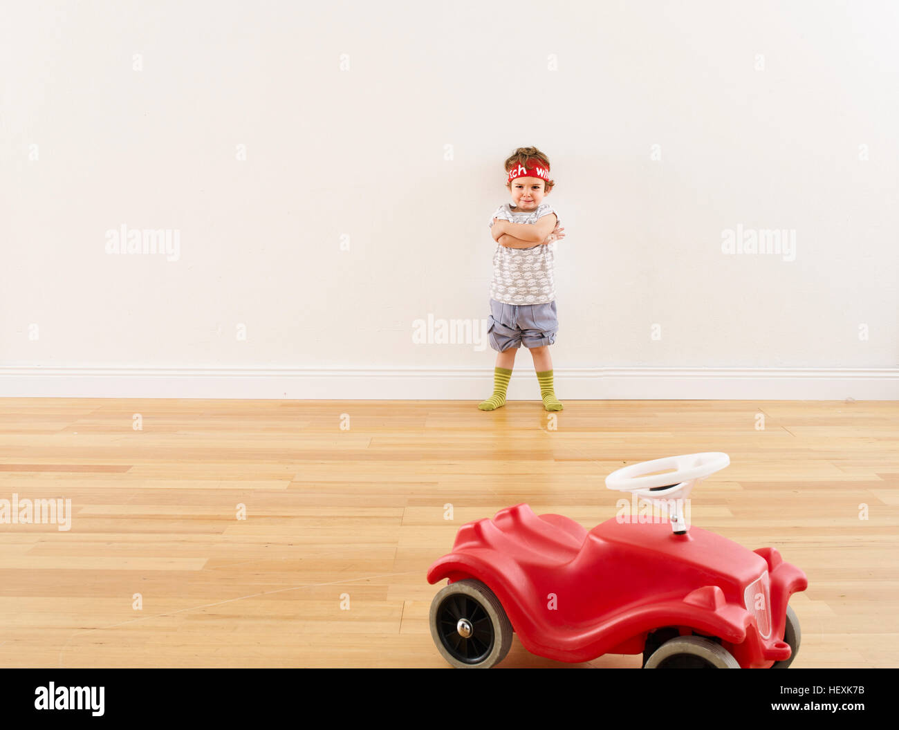 Little girl playing with pedal car Stock Photo Alamy