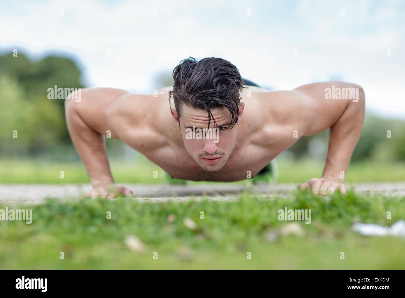 Young man doing push ups Stock Photo - Alamy