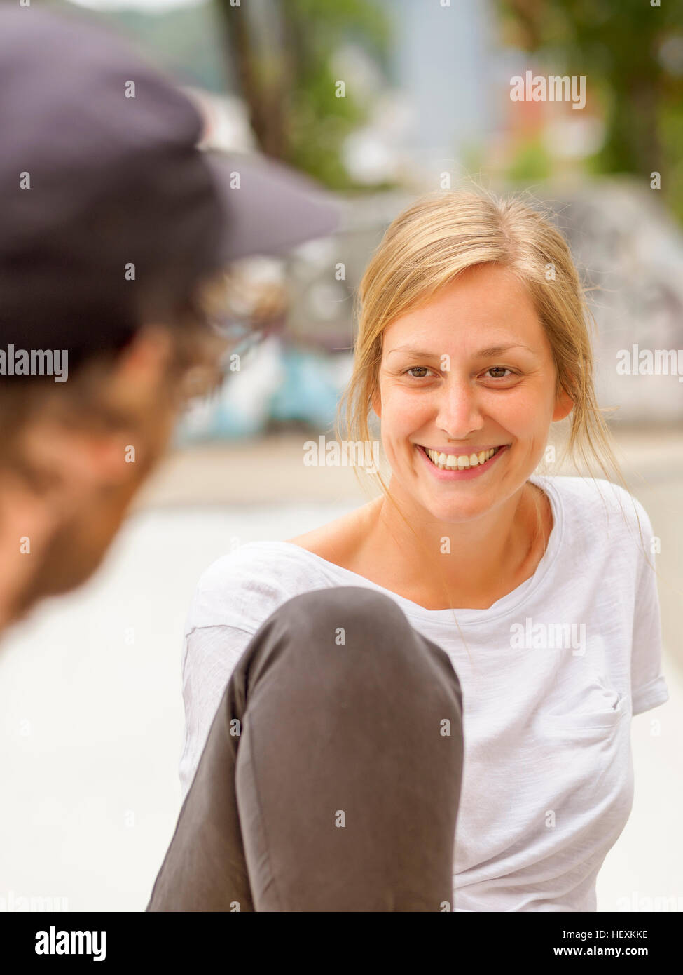Young man and woman talking Stock Photo - Alamy