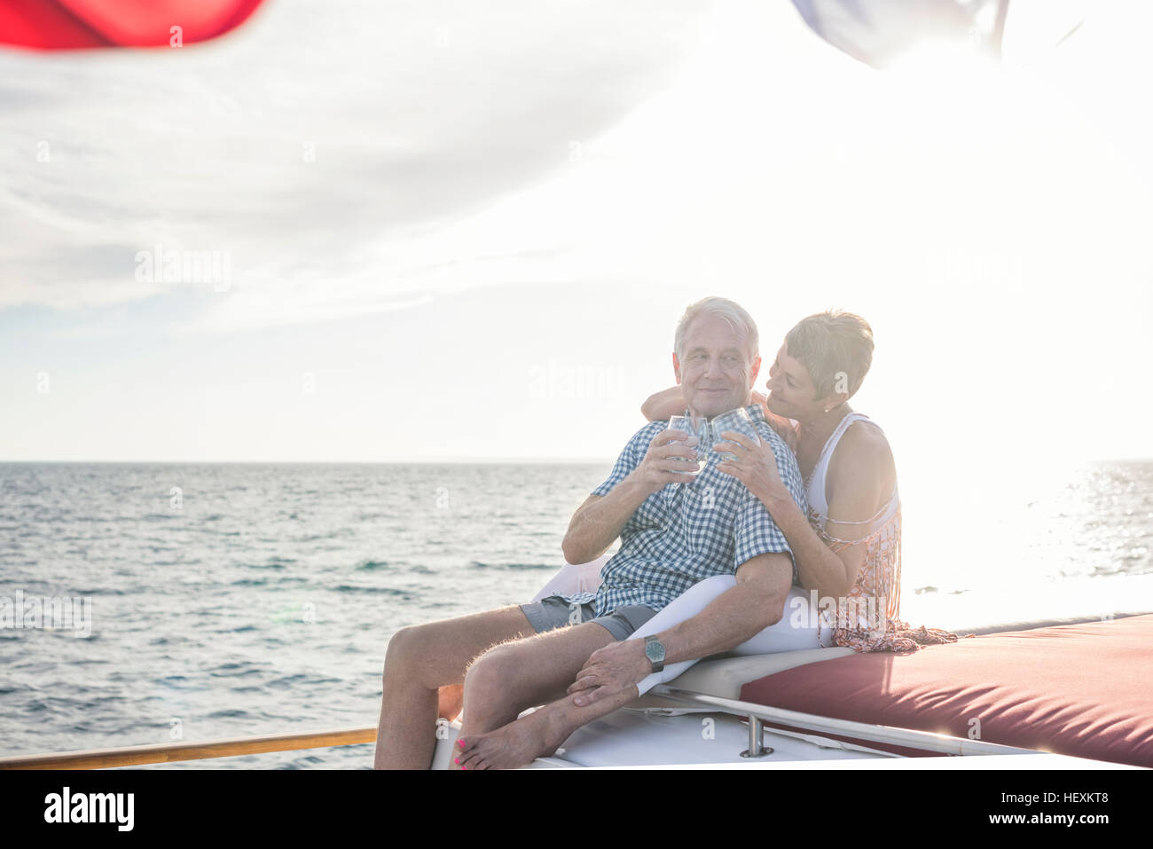 Happy couple having a drink on a boat trip Stock Photo Alamy