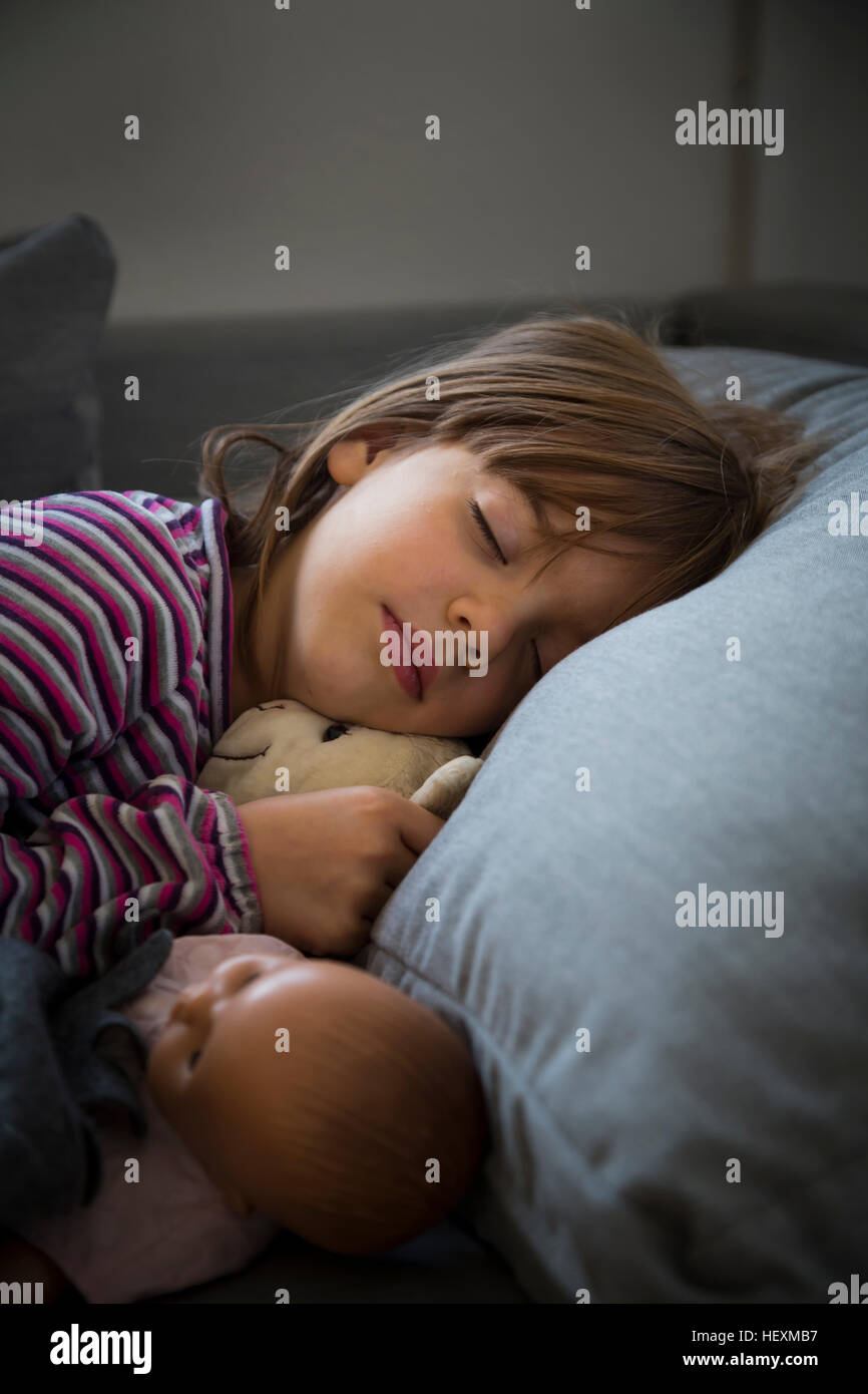 Portrait of little girl sleeping on couch Stock Photo Alamy