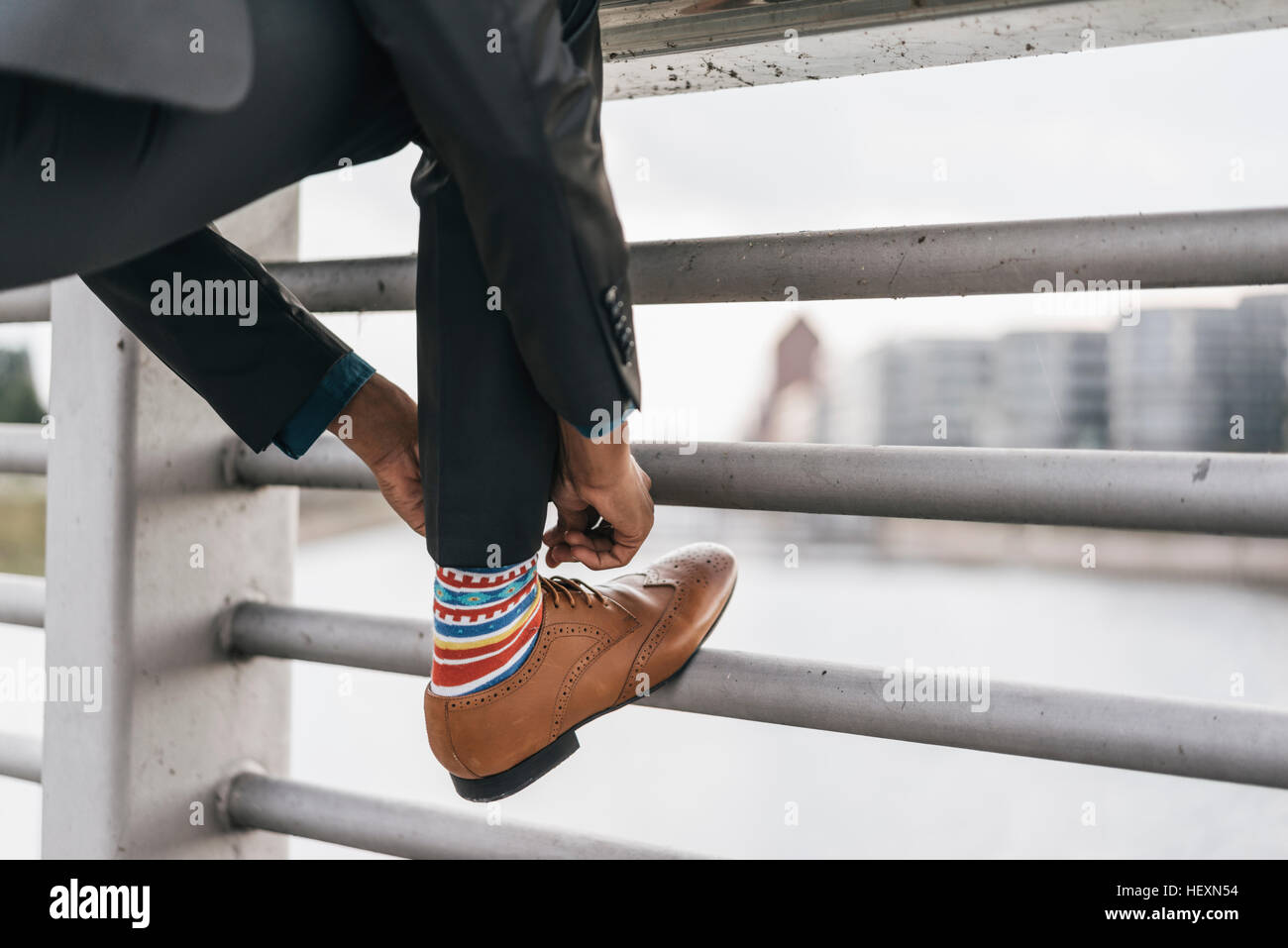 Young businessman tying shoe laces Stock Photo