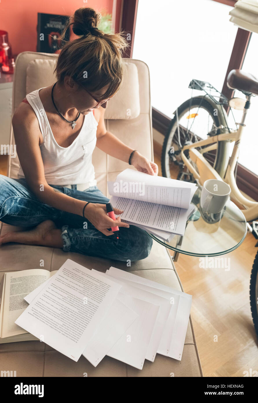 Woman at home working on script Stock Photo
