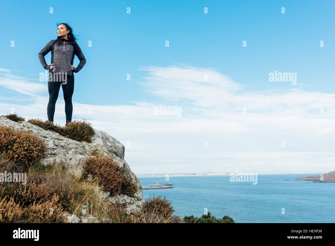 Female athlete standing at cliff hi-res stock photography and images ...