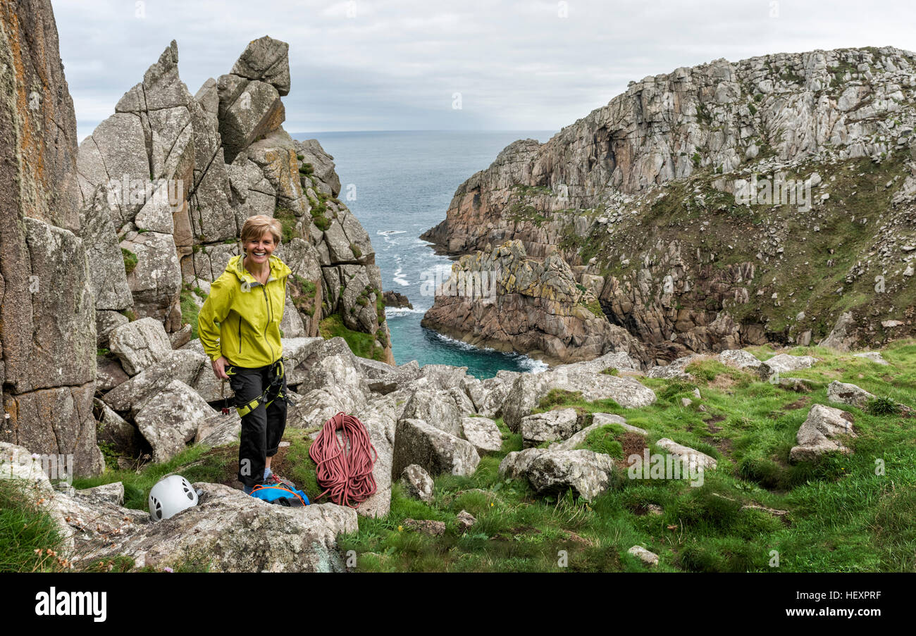 UK, Cornwall, smiling woman preparing for climbing Commando Ridge route Stock Photo