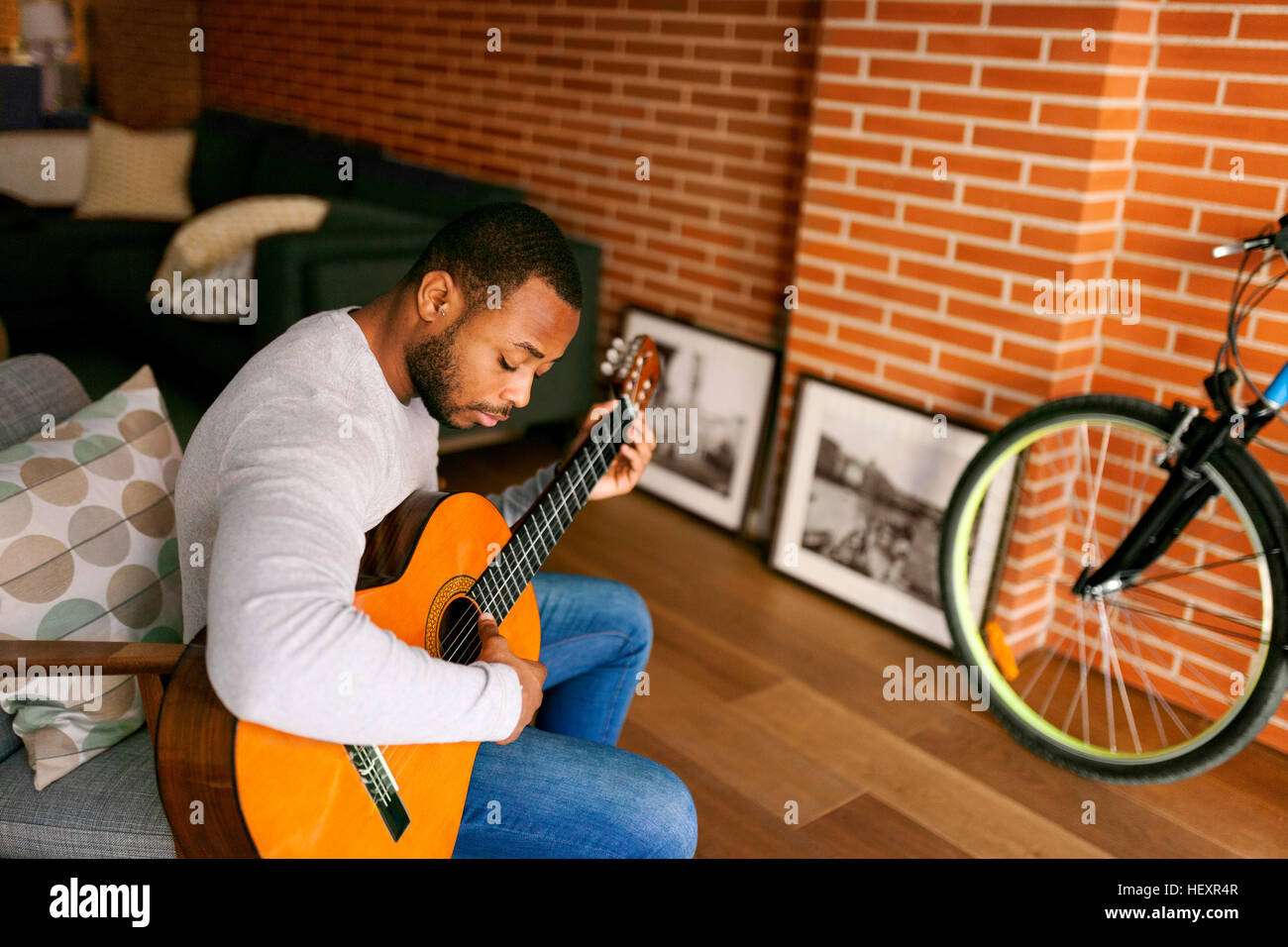 Young man at home playing guitar Stock Photo - Alamy