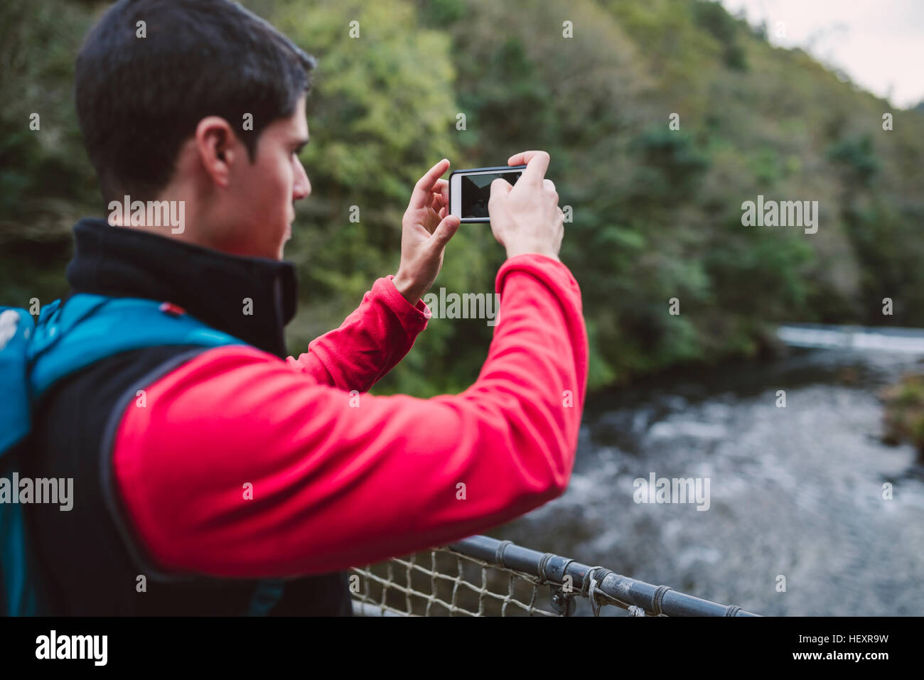 Hiker taking a photo in nature Stock Photo
