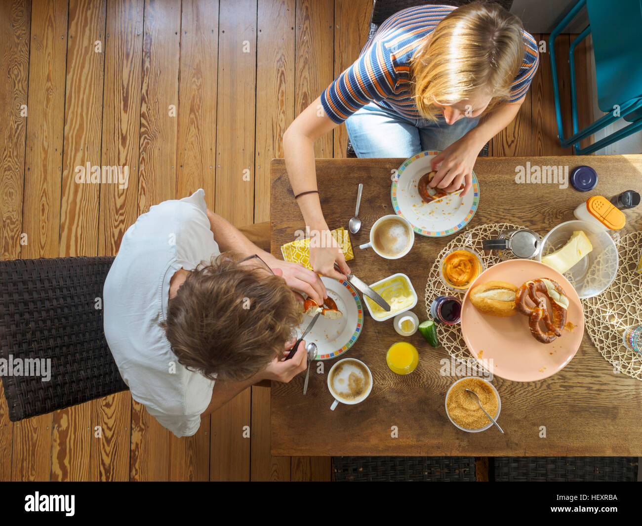 Young couple sitting at table, having breakfast, overhead view Stock Photo