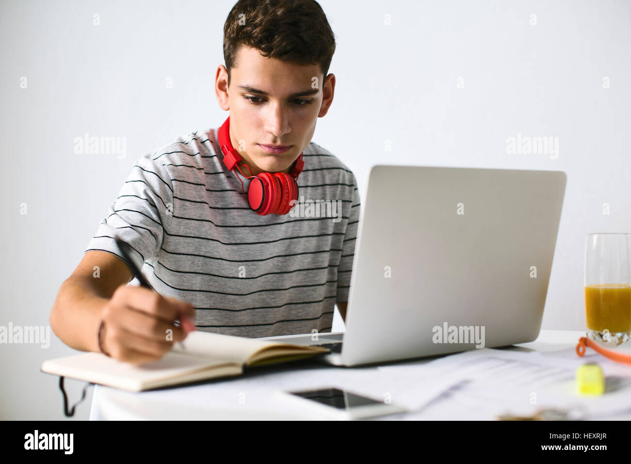 Teenage boy doing homeworks with laptop Stock Photo - Alamy