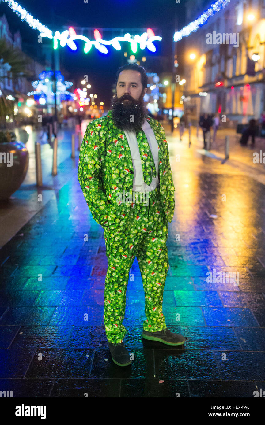 A reveller with a sprout suit on St. Mary's Street during Black Friday in Cardiff, South Wales. Stock Photo