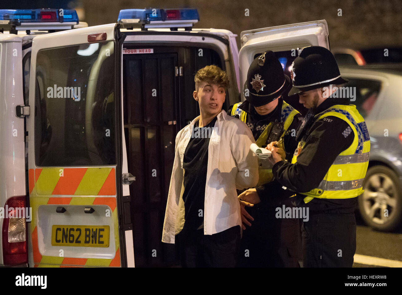 A police officer handcuffs a man following an incident outside the