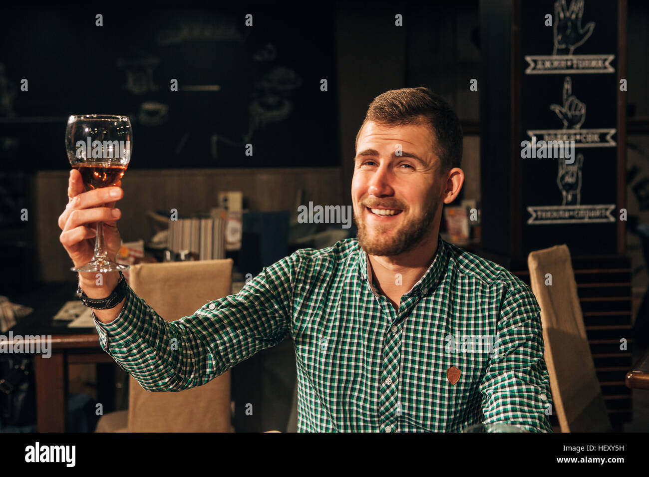 young handsome man drinking wine in a restaurant Stock Photo