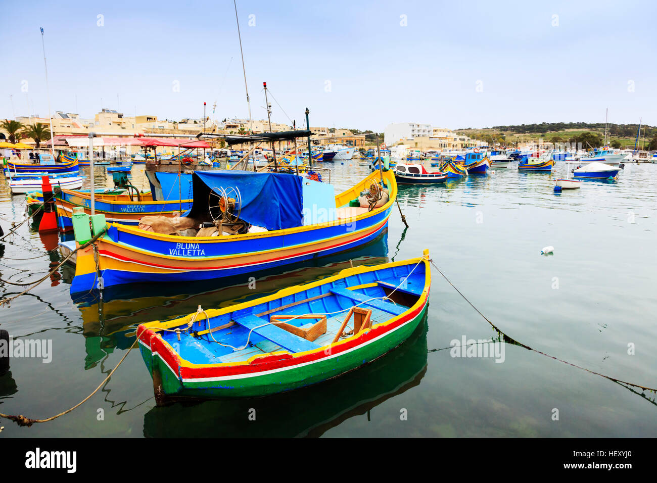 Traditional Maltese luzzu fishing boats in Marsaxlokk harbour, Malta Stock Photo